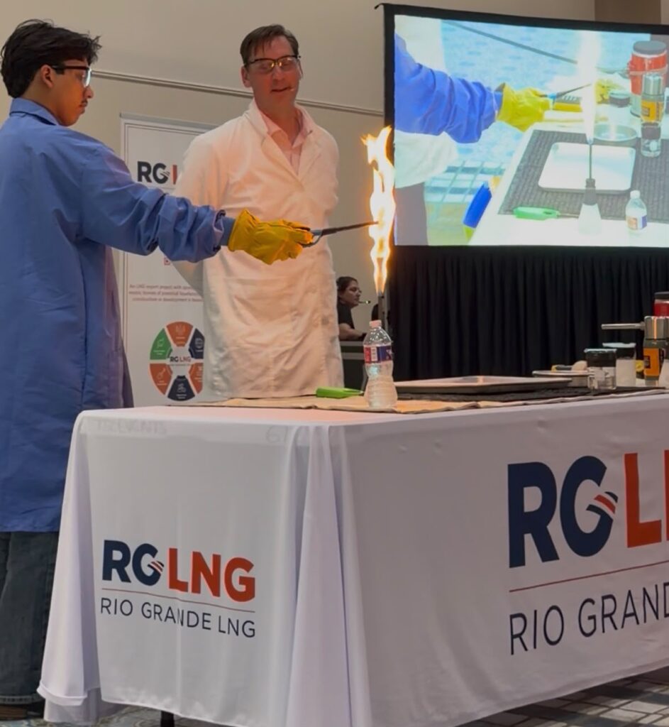 Texas Southmost College student Jorge Garza holds a flaming ignition wand during a liquefied natural gas safety demonstration led by engineer Patrick Couch in Brownsville.