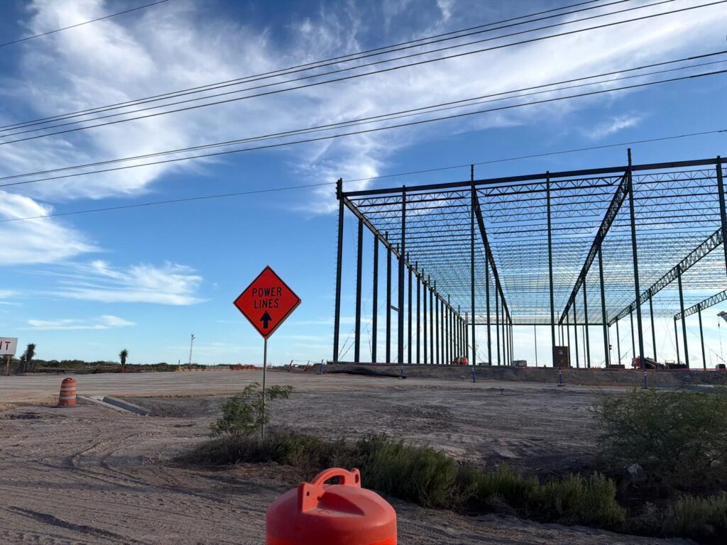 Steel framework of a large structure under construction at SpaceX’s Starbase complex in South Texas.